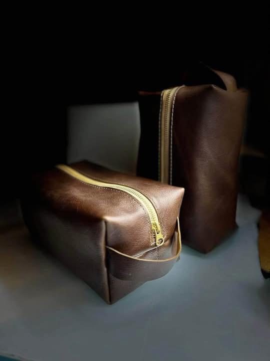 Two brown leather Dopp kits