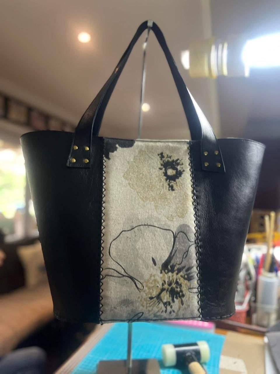 Black leather tote with abstract floral panel