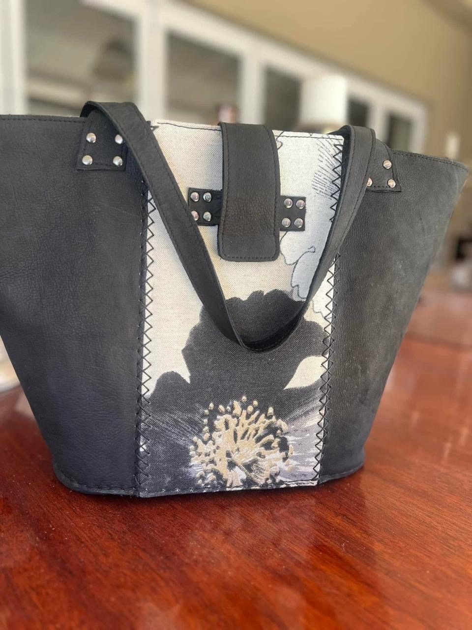 Black leather tote with abstract floral panel