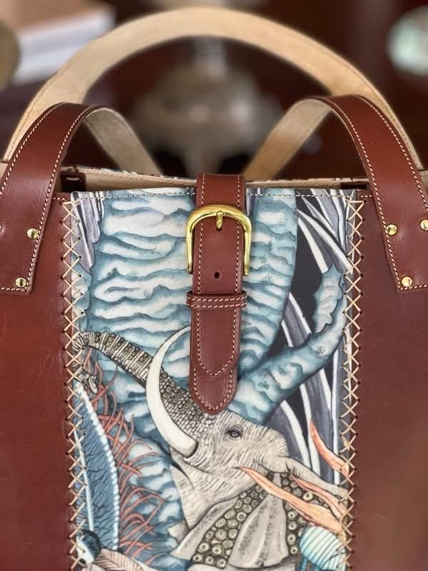 Close-up of an elephant tapestry panel and brass buckle
