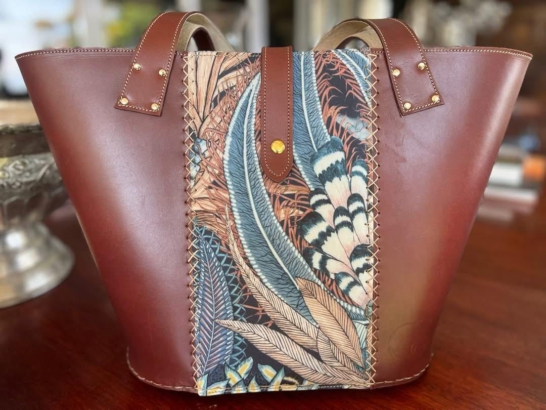 Maroon leather tote with feather tapestry panel