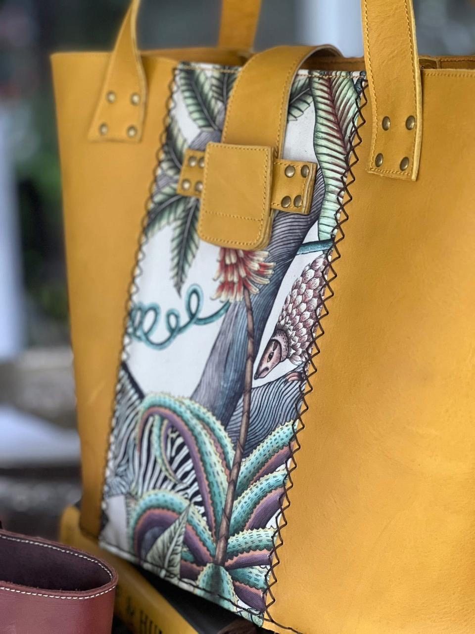 Close-up of a zebra and aloe tapestry panel on a mustard tote