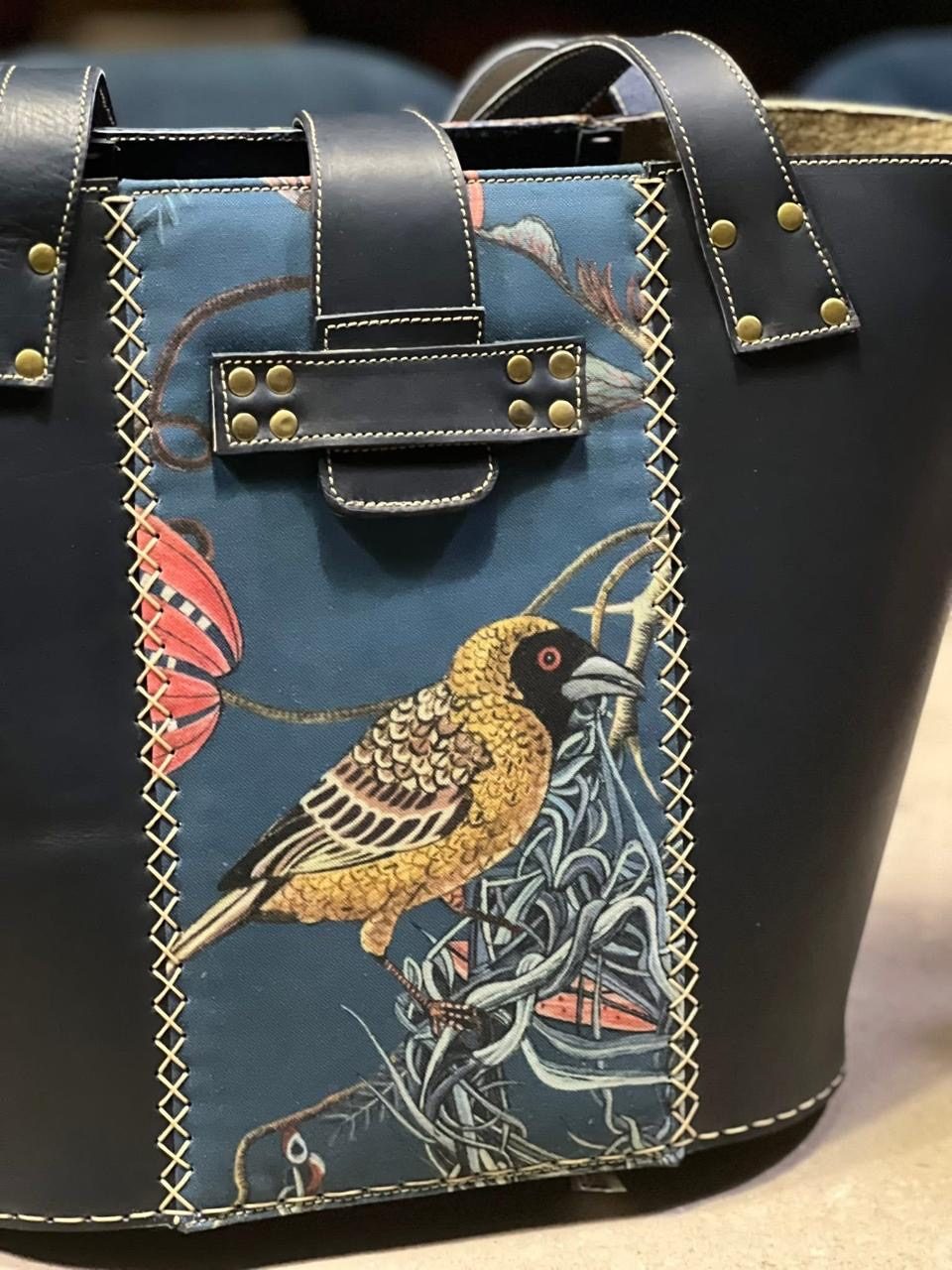 Close-up of a weaver bird tapestry panel