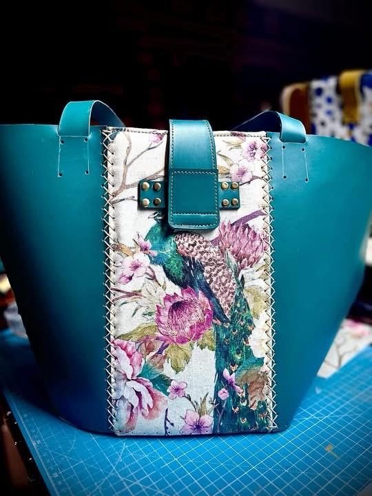 Teal leather tote with peacock and floral panel