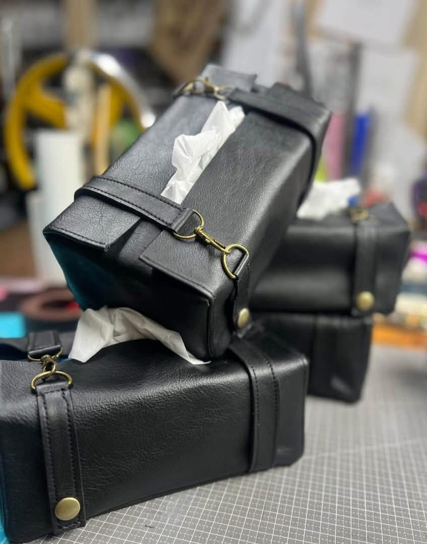 Black leather travel pouch set in the workshop